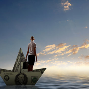 man sailing on a large folder dollar bill boat on open seas with clear skies