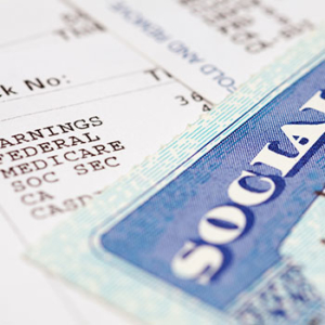Zoomed in image of part of a social security card and bank notices and payments