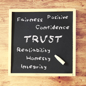 Chalkboard with the words, fairness positive, trust, reliability, honesty, and integrity written on it.